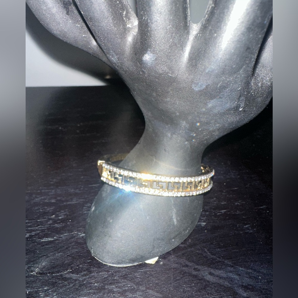 Gold bracelets with shiny gems